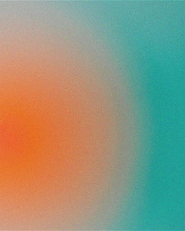 Abstract blur of orange against a teal background.