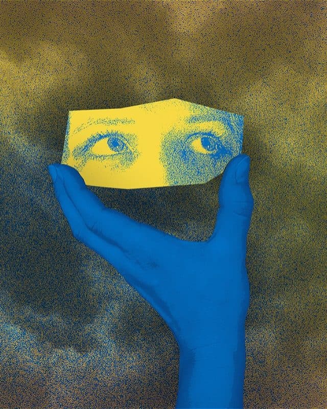 A blue hand holds a cut-out of eyes looking up to the right, avoiding eye contact with the viewer and appearing innocent. The foreground is a pixelated, fuzzy image of clouds. The colours are blue, yellow and mixes in between.