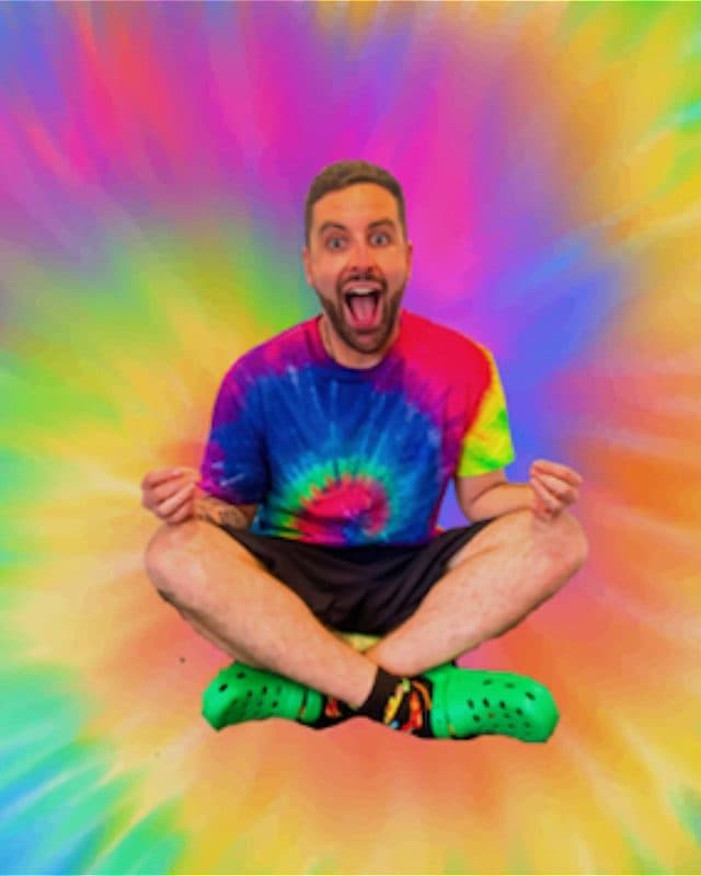 In the centre a young man sits cross-legged in a meditation position, surrounded by swirling rainbow colours.
His mouth is wide open in a comical scream.